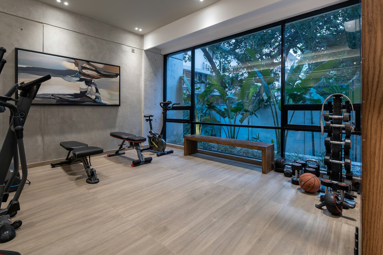 Home gym with a weight bench and a dumbbell rack