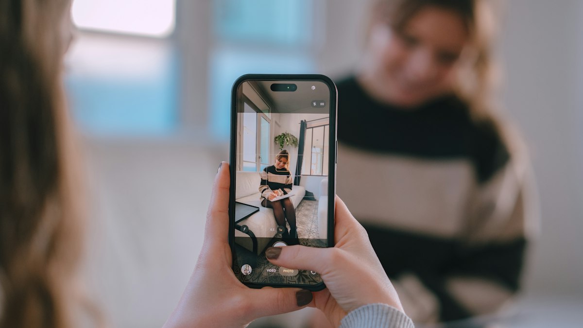 Phone recording a video of a woman at home